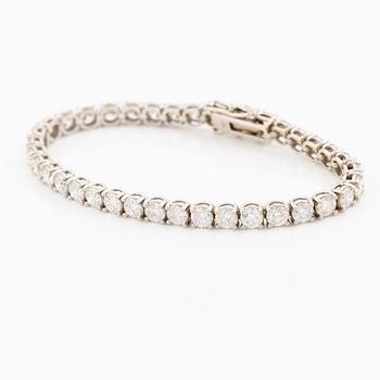 A tennis bracelet in 18K white gold set with round brilliant-cut diamonds total ca 11.50 ct, accompanied by GIA dossier.