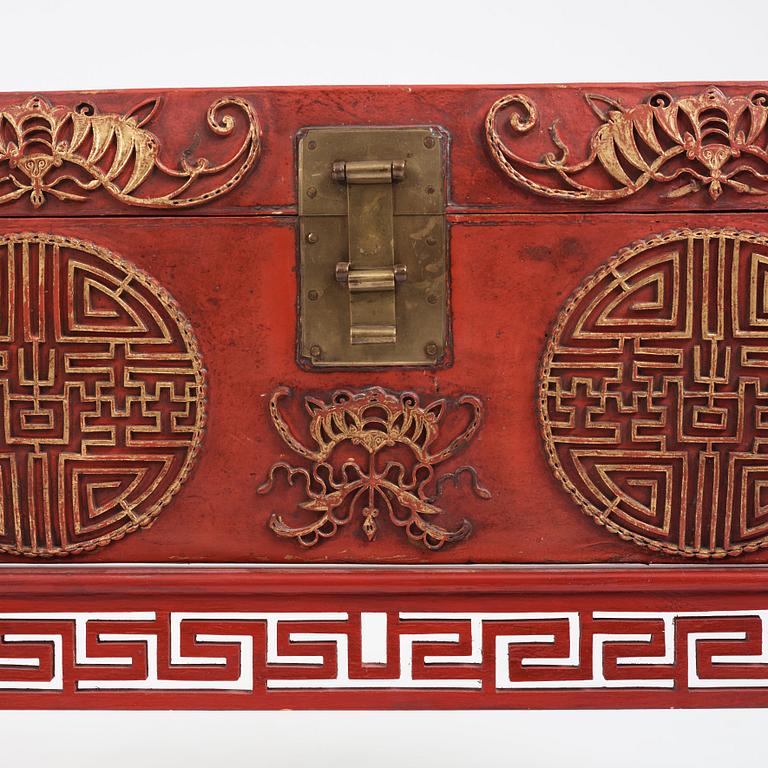 A red lacquered chest on a later stand, late Qing dynasty, 19th Century.