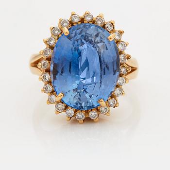 903. A RING set with a faceted sapphire.