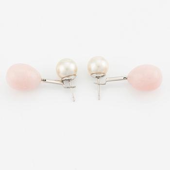 A pair of 18K white gold Gaudy earrings with cultured South Sea pearls and pink coral drops.