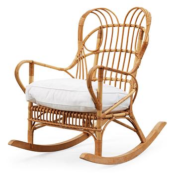 A Josef Frank ratten and beech rocking chair, Svenskt Tenn, model 1077, 1940's-50's.