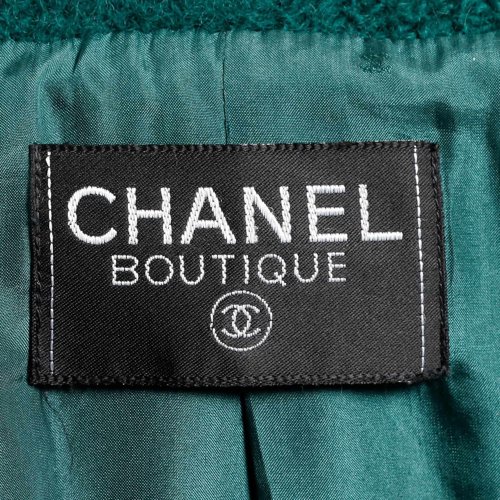 CHANEL, a two-piece suit consisting of short jacket and skirt.