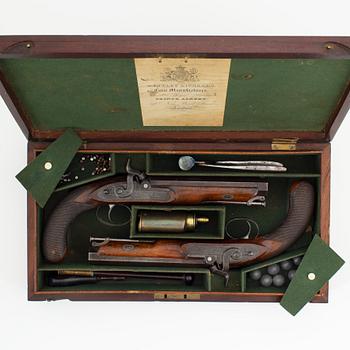 A cased pair of percussion pistols by Westley Richards, London, mid 19th Century.