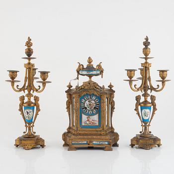 A pair of candelabras and a mantel clock, late 19th Century.