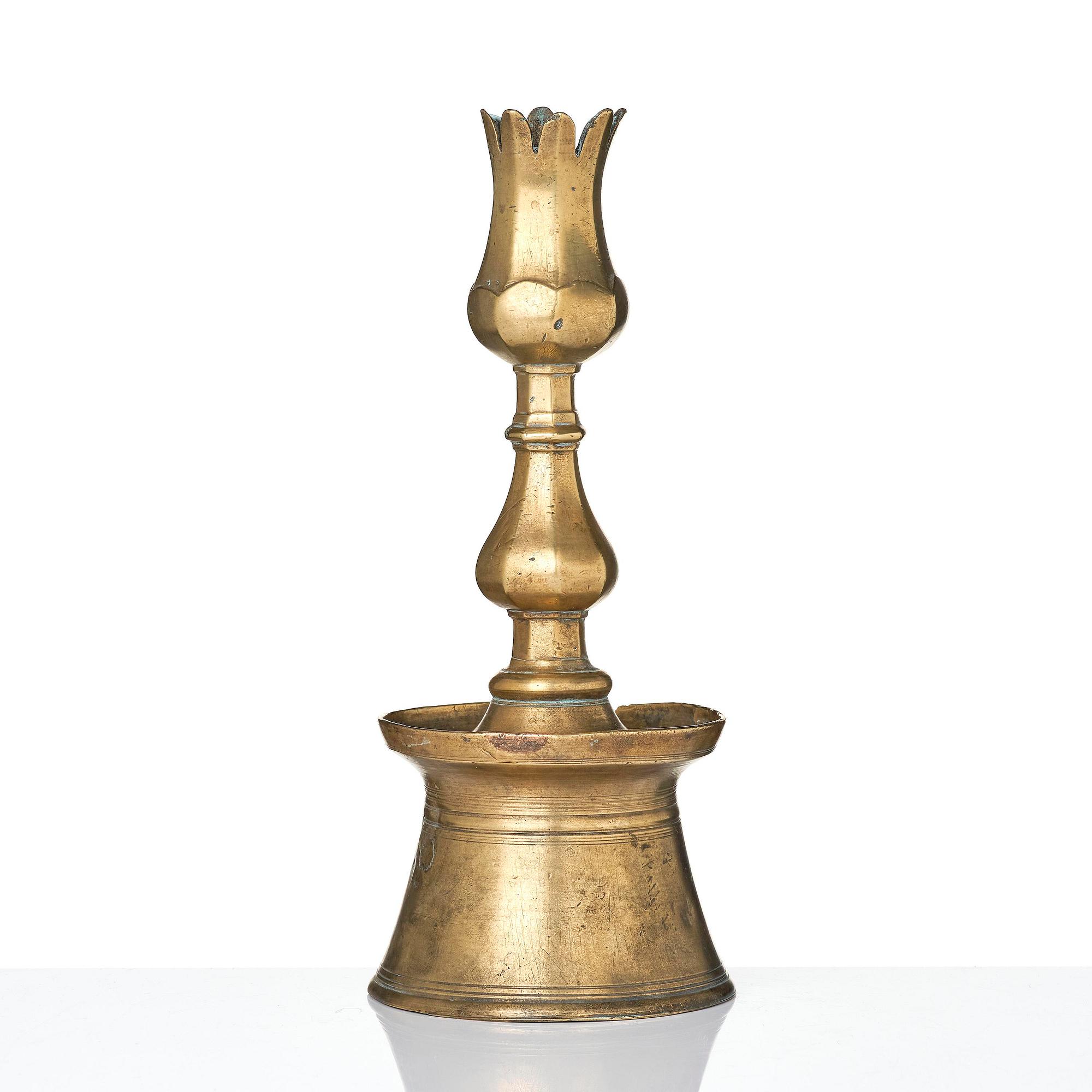 An Ottoman brass 'Tulip' Candelstick, Turkey, 17th/18th century.