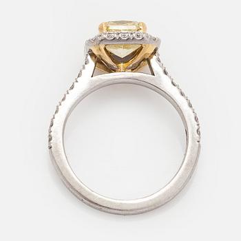 platinum ring with yellow radiant-cut diamond and brilliant cut diamonds.
