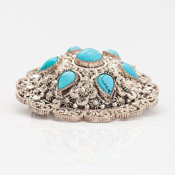 A silver bracelet and ring with turquoises. China.
