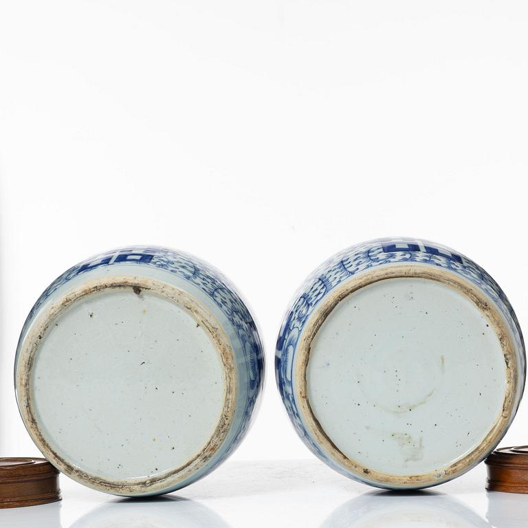 A pair of Chinese blue and white porcealin jars with wooden covers, Qing dynasty, 19th Century.
