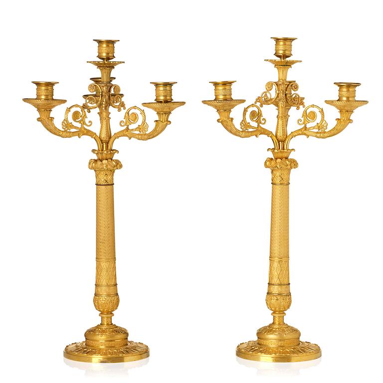 A pair of French Empire four-light gilt bronze candelabra, early 19th century.