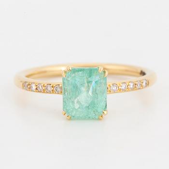 Emerald-cut  pale emerald and brilliant-cut diamond ring.