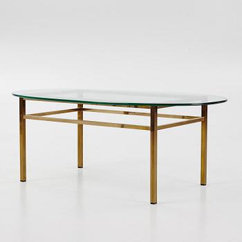 A 1970's glass and brass coffee table.