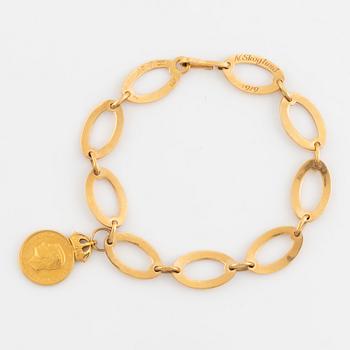 18K gold bracelet, with charm medal.