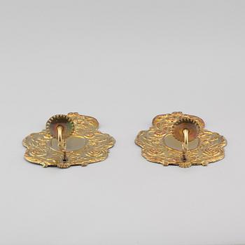 A pair of wallplates made of brass, 20th century.