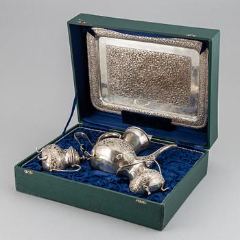 A Pakistan silver coffee pot, sugar bowl, sugar tongs and creamer.