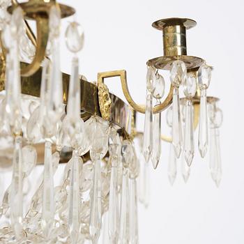 A Swedish gilt brass and cut glass thirteen-light Empire chandelier, early 19th century.