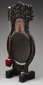 A bronze gong with a wooden stand, Qing dynasty.