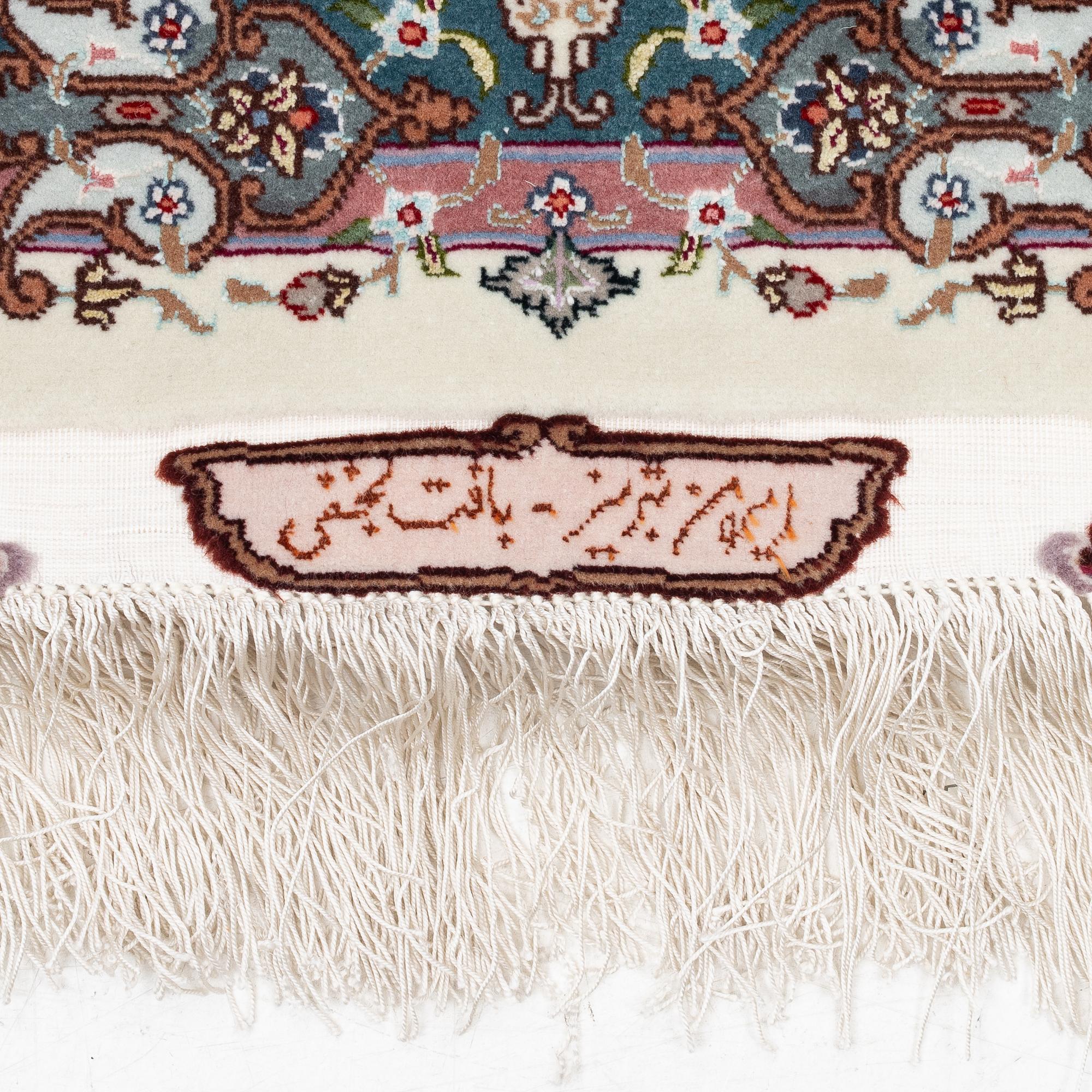 A Tabriz carpet, 210 x 195 cm. signed.