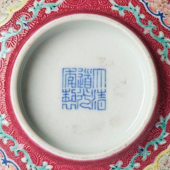 A famille rose ruby ground sgrafitto 'landscape' bowl, Qing dynasty, seal mark and period of Daoguang (1820-50).