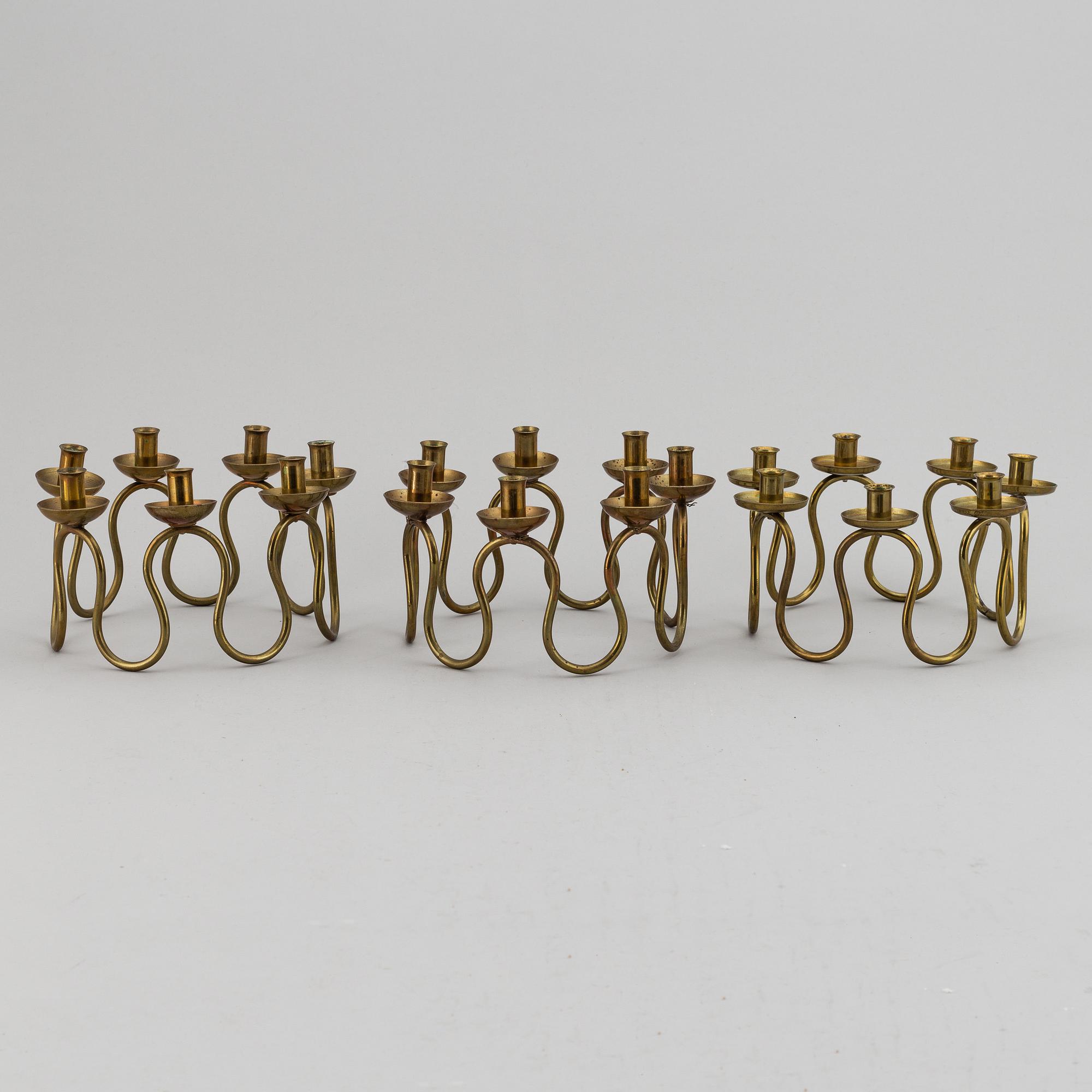 LARS HOLMSTRÖM, Three brass candelabra, Arvika, mid 20th Century.