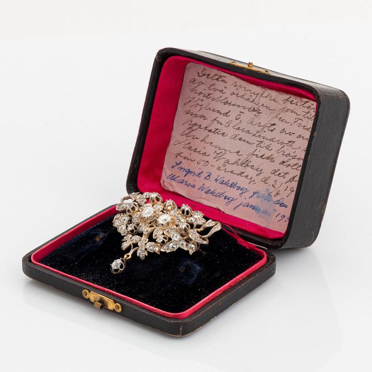 A silver brooch set with old-cut diamonds.