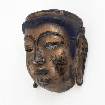 A lacquered wooden mask, 20th century.