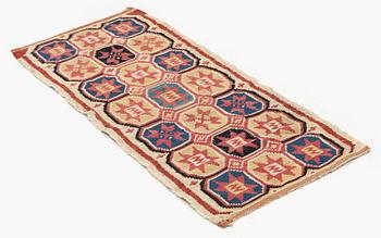 A carrige cushion, flat weave, c. 100 x 43 cm, Scania, 1790-1810.