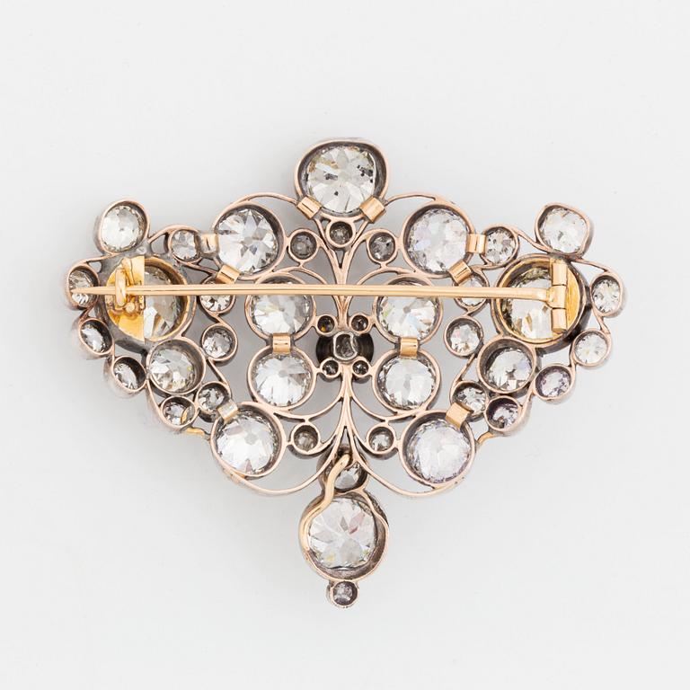 A gold and silver brooch set with old-cut diamonds.