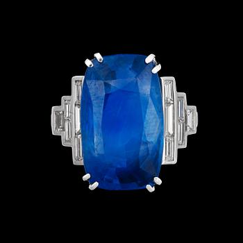 1201. An untreated sapphire ring, 15.80 cts, set with step cut diamonds.