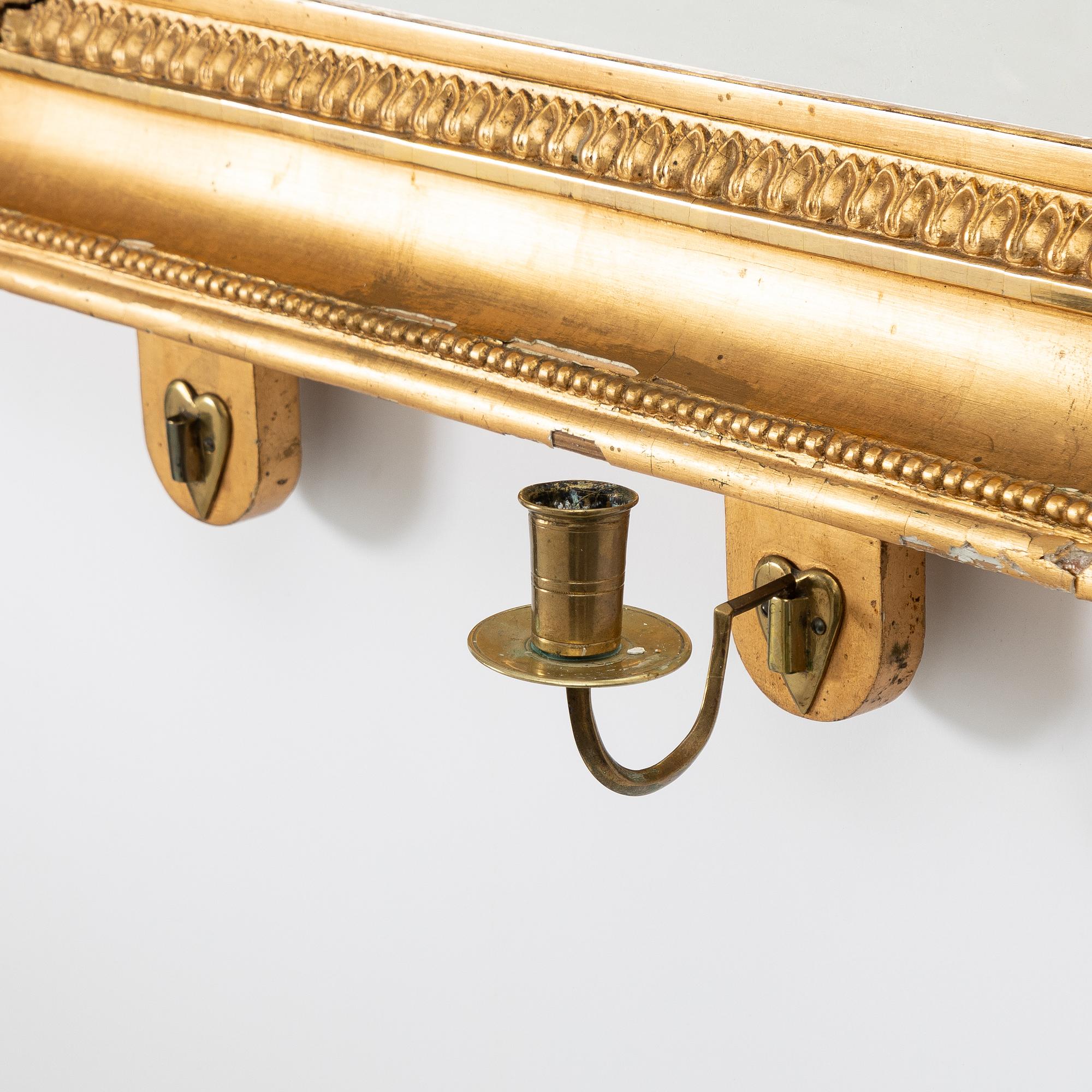 A pair of Late Empire gilded mirror sconces for two candles, Gothenburg, 1830s-40s.