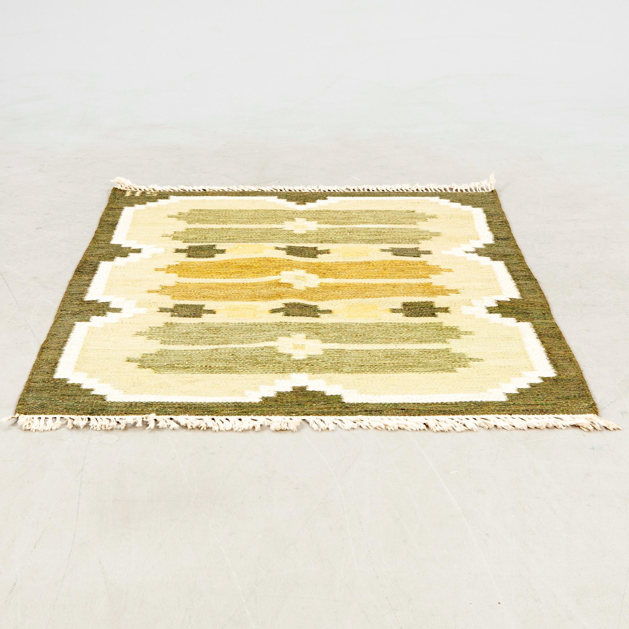 Flat-weave rug signed SH, approximately 194x133 cm.