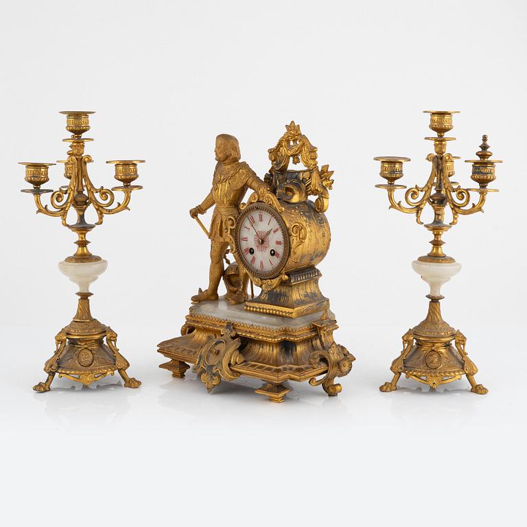 A mantel clock and a pair of candelabra, P.H. Mourey, France, late 19th Century.