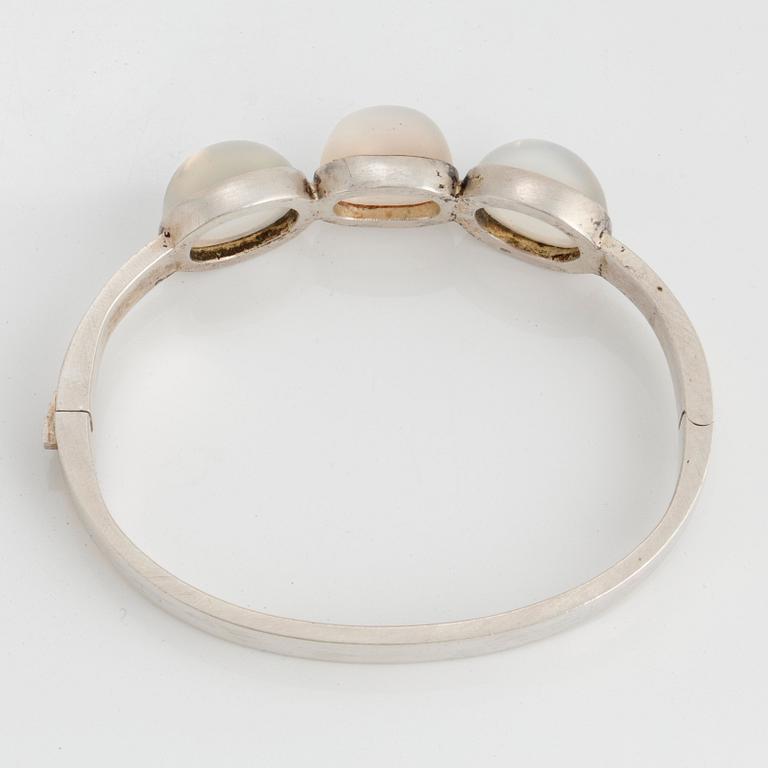 Wiwen Nilsson, a sterling silver bangle with three cabochon cut moonstones, Lund, Sweden 1938.