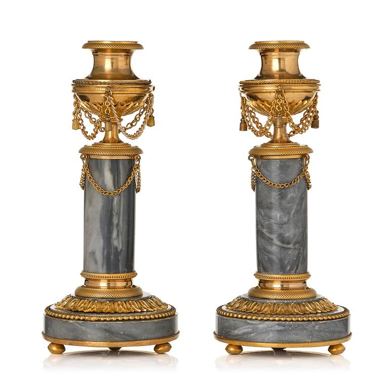 A pair of Louis XVI ormolu and Bleu turquin candlesticks.