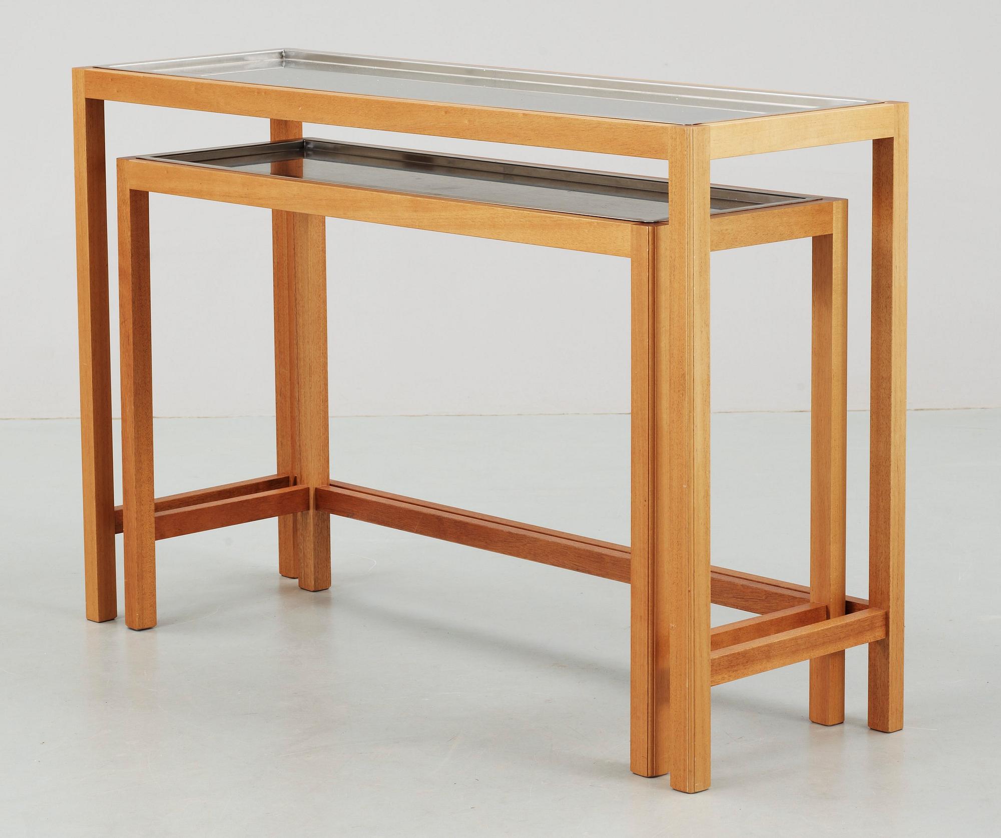 A Josef Frank set of mahogany and stainless steel tables by Svenskt Tenn.