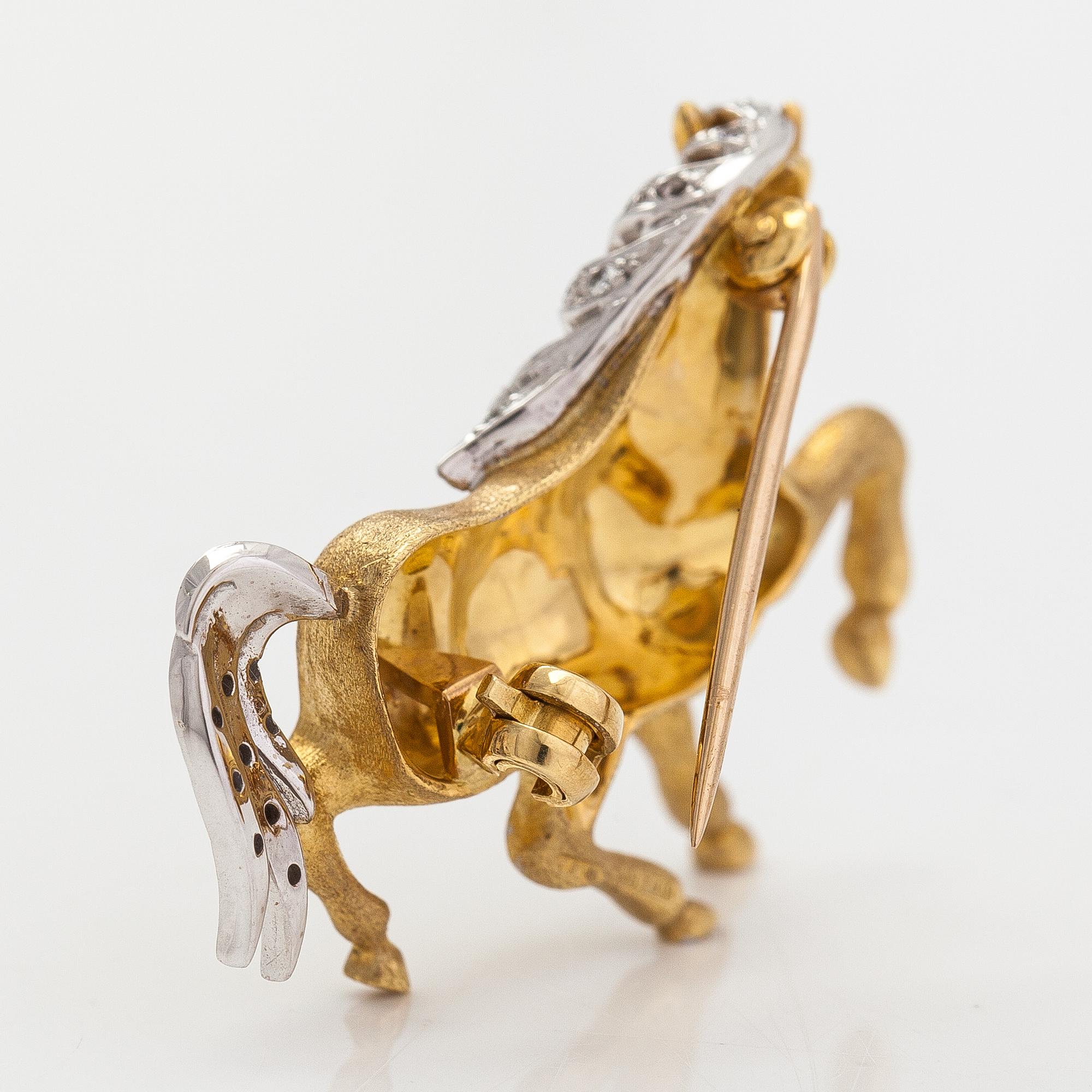 An 18K gold horse brooche with diamonds ca. 0.04 ct in total. United Kingdom.