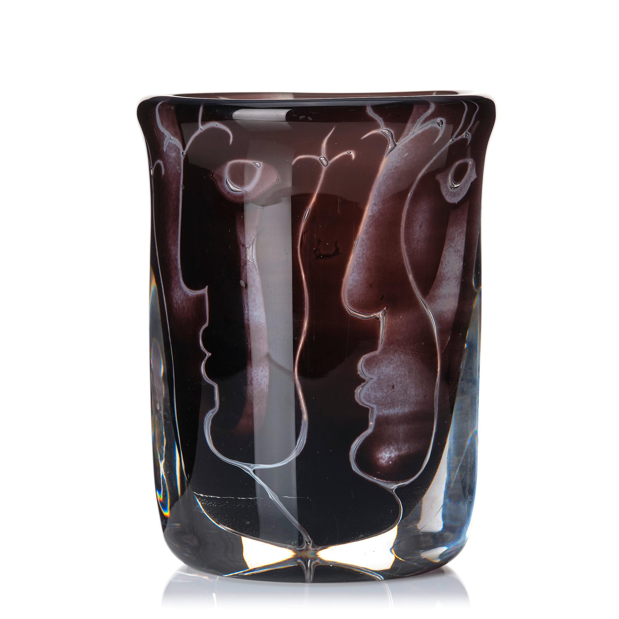 Ingeborg Lundin, an 'ariel' burgundy coloured glass vase decorated with faces, Orrefors Sweden 1972.