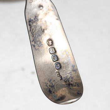 Seven silver spoons, including English and Swedish hallmarks.