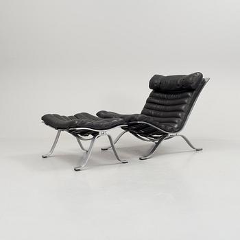 A black leather "Ari" easy chair with foot stool by Arne Norell for Norell möbler.