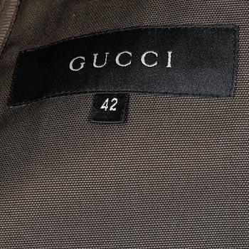 GUCCI, a three-piece suit consisting of jacket, shirt and skirt.