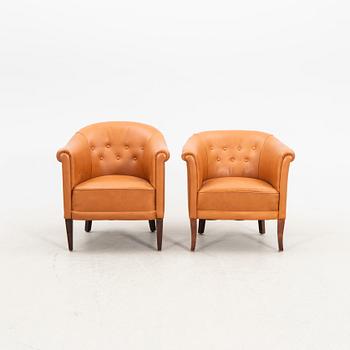 A set of two  1940s leather armchairs.