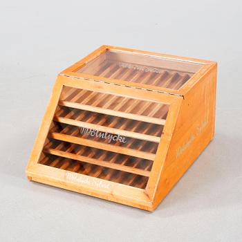 A wooden box with glass for spools of thread, mid 20th century.