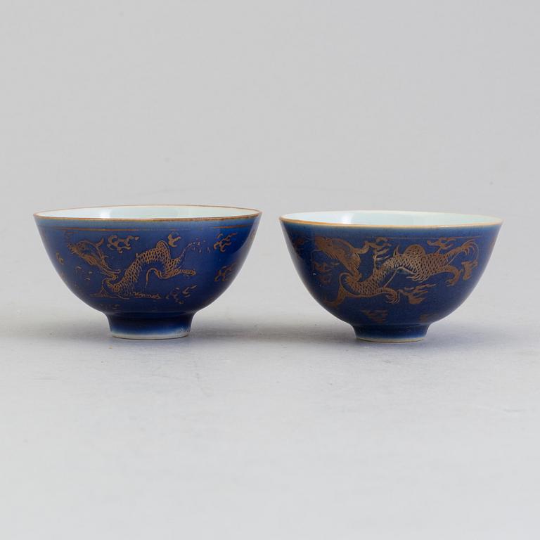 A pair of Chinese powder blue porcelain cups with dishes, Qing dynasty, Qianlong (1736-95), with Qianlongs mark.