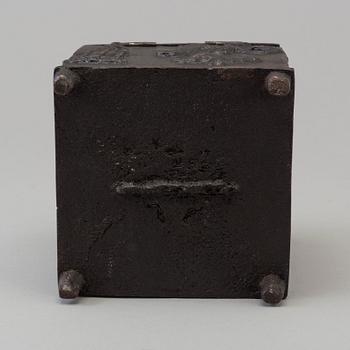 An empire cast iron tobacco box, dated 1838.
