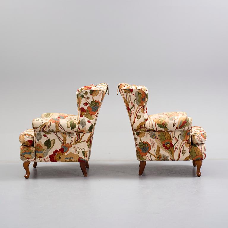 A pair of 20 th century arm chairs.