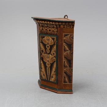 A painted corner cabinet, dated 1794.