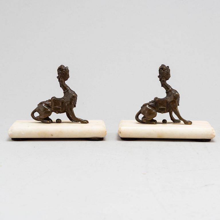 A pair of bronze sculptures on marble plinths, ca 1900.