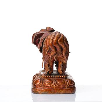 A cold gilt and lacquered copper alloy sculpture of a buddhist lion, Tibeto-Chinese/Mongolian, 18th Century.