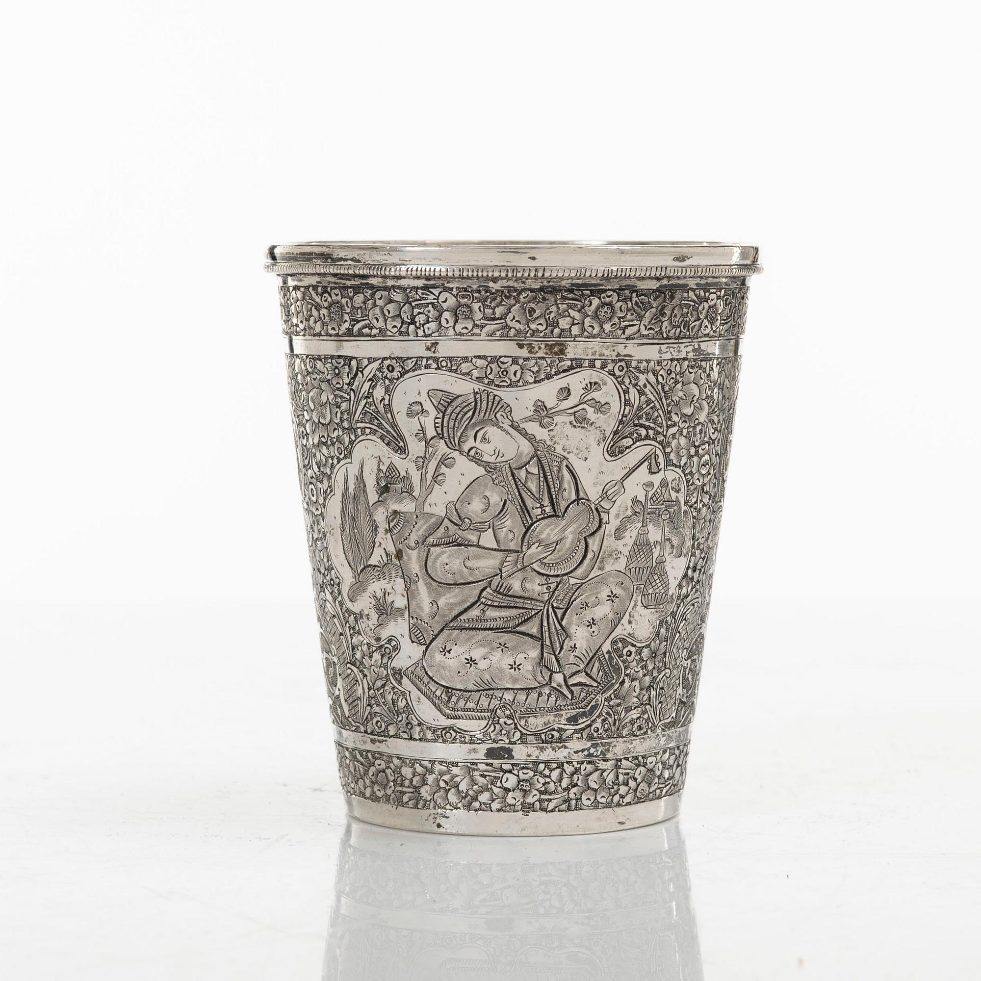 A Persian silver pitcher with five stemmed cups and a beaker, first part of the 1900s.