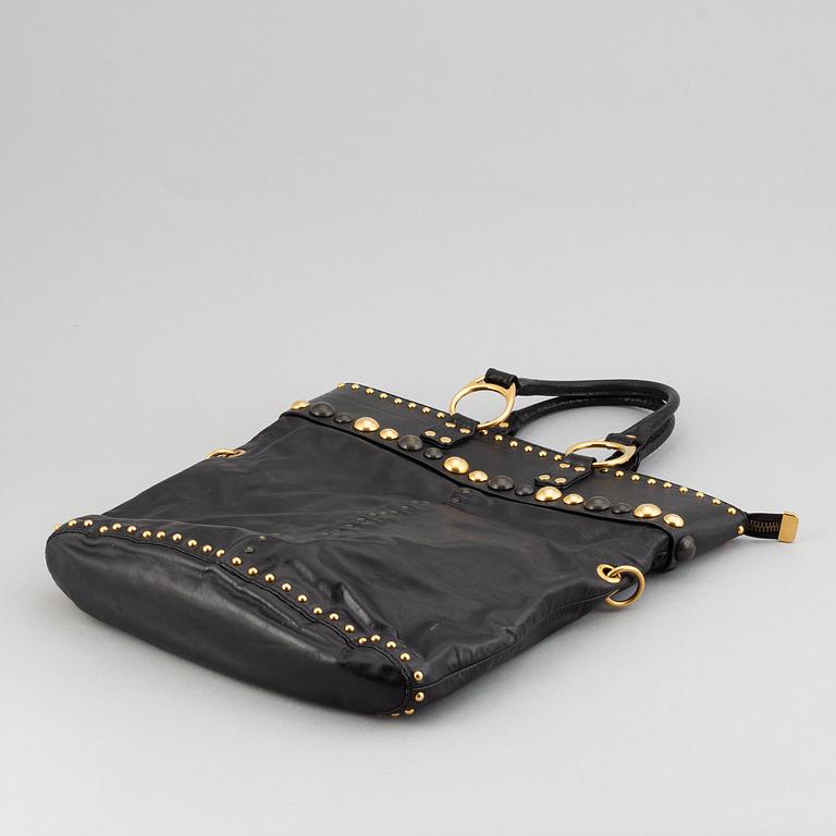 Gucci, a black leather handbag.