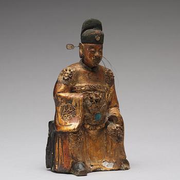 A lacquered and gilt ceramic sculpture of a deity, Ming dynasty (1368-1644).